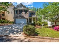 Charming two-story home with brick and siding, a well-manicured lawn, and an inviting entrance at 416 Wilfawn Way, Avondale Estates, GA 30002
