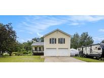 Charming two-story home featuring a two-car garage and a lovely front porch in a suburban setting at 2730 Milton Bryan Dr, Loganville, GA 30052