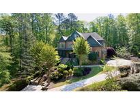 Charming two-story brick home surrounded by mature trees and professionally landscaped grounds at 310 Anders Path, Marietta, GA 30064
