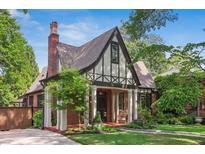 Charming Tudor-style home featuring a brick facade, pitched roof, and well-manicured front yard at 26 Clarendon Ave, Avondale Estates, GA 30002
