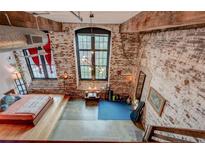 Spacious bedroom with exposed brick wall, large window and industrial chic design at 170 Boulevard # H201, Atlanta, GA 30312