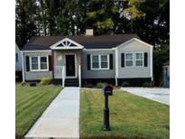 Charming one-story home with a well-manicured lawn and inviting walkway to the front door at 1740 Emerald Ave Ave, Atlanta, GA 30310