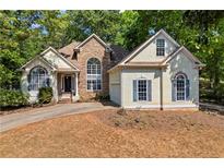 Charming home featuring stone accents, lush landscaping, and a welcoming front entrance at 115 Stonewall Dr, Covington, GA 30016