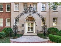 Elegant building entrance with ornate ironwork archway and well-manicured landscaping at 1325 Peachtree Ne St # 401, Atlanta, GA 30309