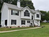 Charming two-story home with light siding, black shutters, attached garage, and a manicured front yard at 6397 Autumn View Nw Trce, Acworth, GA 30101