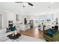 Bright, open-concept living space featuring a modern kitchen with stainless steel appliances and a cozy dining area at 522 Pearl St, Cumming, GA 30040