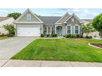 Charming single-story home with a well-manicured lawn, stone accents, and a welcoming front porch at 912 Santa Anita Dr, Woodstock, GA 30189