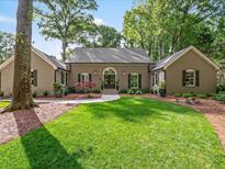 Charming single-story brick home with a well-manicured lawn and inviting walkway at 4643 River Ct, Peachtree Corners, GA 30097