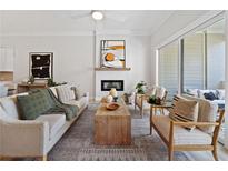 Comfortable living room with modern decor, fireplace, and sliding glass doors to the outside patio at 677 Stickley Oak Way, Woodstock, GA 30189
