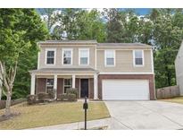 Charming two-story home with a brick facade, a well-manicured lawn, and inviting curb appeal at 1647 Shire Village Dr, Sugar Hill, GA 30518