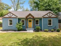 Charming bungalow with blue painted brick, yellow front door, tidy landscaping and a new roof at 1798 S Gordon Sw St, Atlanta, GA 30310