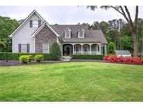 Charming home with manicured lawn, stone accents, and inviting front porch at 18 Spring Lake Ne Trl, White, GA 30184