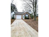 Charming brick home featuring an attached garage and a well-maintained front yard at 3647 Diamond Cir, Decatur, GA 30034