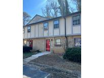Charming townhouse features a brick facade, red door, and well-maintained landscaping at 1151 Rankin St # 2B, Stone Mountain, GA 30083