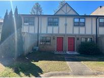 Two-story townhouse featuring dual front doors and classic design, set against a vibrant blue sky at 1151 Rankin St # 7A, Stone Mountain, GA 30083