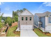 Beautifully designed two-story home with a spacious two-car garage and manicured front lawn at 1954 William Glen St, Dacula, GA 30019
