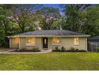 Charming brick ranch home with a manicured lawn and lush greenery creating inviting curb appeal at 2308 Scotty Cir, Decatur, GA 30032