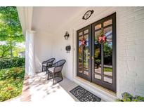 Inviting front porch with double glass doors, white brick, and stylish seating provides curb appeal at 26 Kensington Rd, Avondale Estates, GA 30002