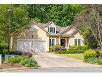 Charming single-Gathering home boasts a two-car garage and manicured landscaping at 2825 Harbor Cove Ct, Cumming, GA 30041