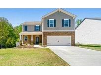 Charming two-story home with a well-manicured lawn and attached two-car garage at 6900 Oak Valley Dr, Douglasville, GA 30134