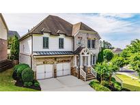 Charming two-story home with a manicured lawn, two-car garage, and a welcoming entrance at 11760 Stratham Dr, Alpharetta, GA 30009
