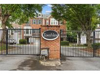 Community entrance gate featuring a secure entry to TownView homes and well-maintained landscaping at 632 Plaza Se Dr # 6, Kennesaw, GA 30144