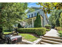 Charming two-story home with a welcoming front porch and professionally landscaped front yard with a defined walkway at 647 East Ne Ave, Atlanta, GA 30312