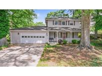 Charming two-story home with a two-car garage, covered porch, and well-maintained landscaping at 15 Ashton Pl, Covington, GA 30016