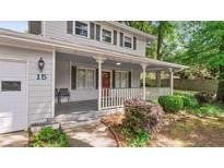 Charming two-story home featuring a covered front porch, fresh exterior paint, and a well-manicured front yard at 15 Ashton Pl, Covington, GA 30016