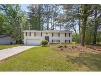 Charming two-story home featuring a classic brick facade, attached garage, and a well-maintained front yard at 6307 Thornhedge Dr, Riverdale, GA 30296