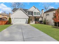 Beautiful new construction home with a well-manicured lawn, a driveway, and a two-car garage at 2383 Colonial Ne Dr, Brookhaven, GA 30319