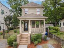 Charming two-story home featuring a welcoming front porch, landscaped yard, and well-maintained exterior at 301 Fortune Ne St, Atlanta, GA 30312