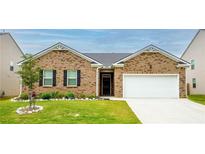 Charming single-story brick home with manicured lawn and attached two-car garage at 5344 Flat Rock Pt, Stonecrest, GA 30038