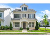 Charming two-story home with neutral siding, dark shutters, manicured lawn and welcoming front porch at 1436 Belmont Ave, Smyrna, GA 30080