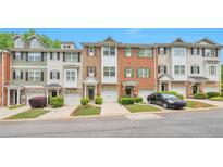 Charming townhomes with manicured lawns, attached garages and unique curb appeal at 3094 Lauren Parc Rd, Decatur, GA 30032