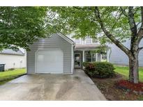 Charming two-story home with a well-manicured front yard and a one-car garage at 6606 Coventry Pt, Austell, GA 30168