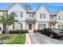 Charming townhouse with well-maintained landscaping, flowerbeds, and private driveway at 7762 Fawn Cir, Covington, GA 30014