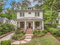 Charming two-story home with landscaped yard, brick stairs, and a welcoming front porch at 686 Amsterdam Ne Ave, Atlanta, GA 30306