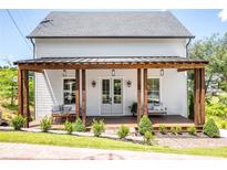 Charming home with a welcoming front porch featuring wooden columns and comfortable seating at 50 Maple St, Roswell, GA 30075
