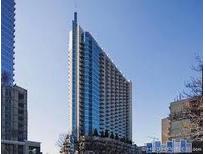 Modern high-rise building with sleek architecture and a view of the surrounding cityscape at 860 Peachtree Ne St # 909, Atlanta, GA 30308