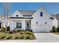 Charming white two-story home with a well-manicured lawn and inviting front porch at 208 Idylwilde Way, Canton, GA 30115