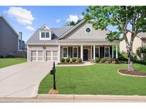 Charming single-Gathering home with a beautifully landscaped front yard and inviting front porch at 100 Inspiration Ln, Dallas, GA 30157