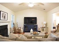 Cozy living room with fireplace, rocking chair, and large-screen television at 1676 Northridge Dr, Morrow, GA 30260