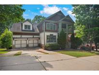 Charming two-story home with a two-car garage and a welcoming front porch in a lush, green neighborhood setting at 2584 Kickerillo Se Way, Atlanta, GA 30316