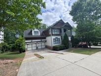 Charming two-story home with a two-car garage and mature trees at 2584 Kickerillo Se Way, Atlanta, GA 30316