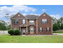 Charming two-story brick home with manicured lawn and inviting front entrance at 108 Telfair Ln, Mcdonough, GA 30253