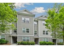 View of modern townhouse with gray siding, white trim, and well-maintained landscaping at 1365 Memorial Se Dr # 12, Atlanta, GA 30317