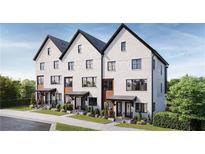 Beautiful new construction townhomes with brick facade, dark windows, and manicured landscaping at 651 Soul Aly # 135, Alpharetta, GA 30009