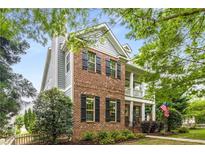 Charming two-story home featuring a brick facade, inviting front porch, and well-maintained landscaping at 3087 Dunton Se St, Smyrna, GA 30080