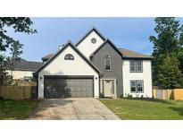 Charming two-story home with gray accents, a spacious two-car garage, and a well-manicured lawn at 1172 Rockmart Nw Cir, Kennesaw, GA 30144